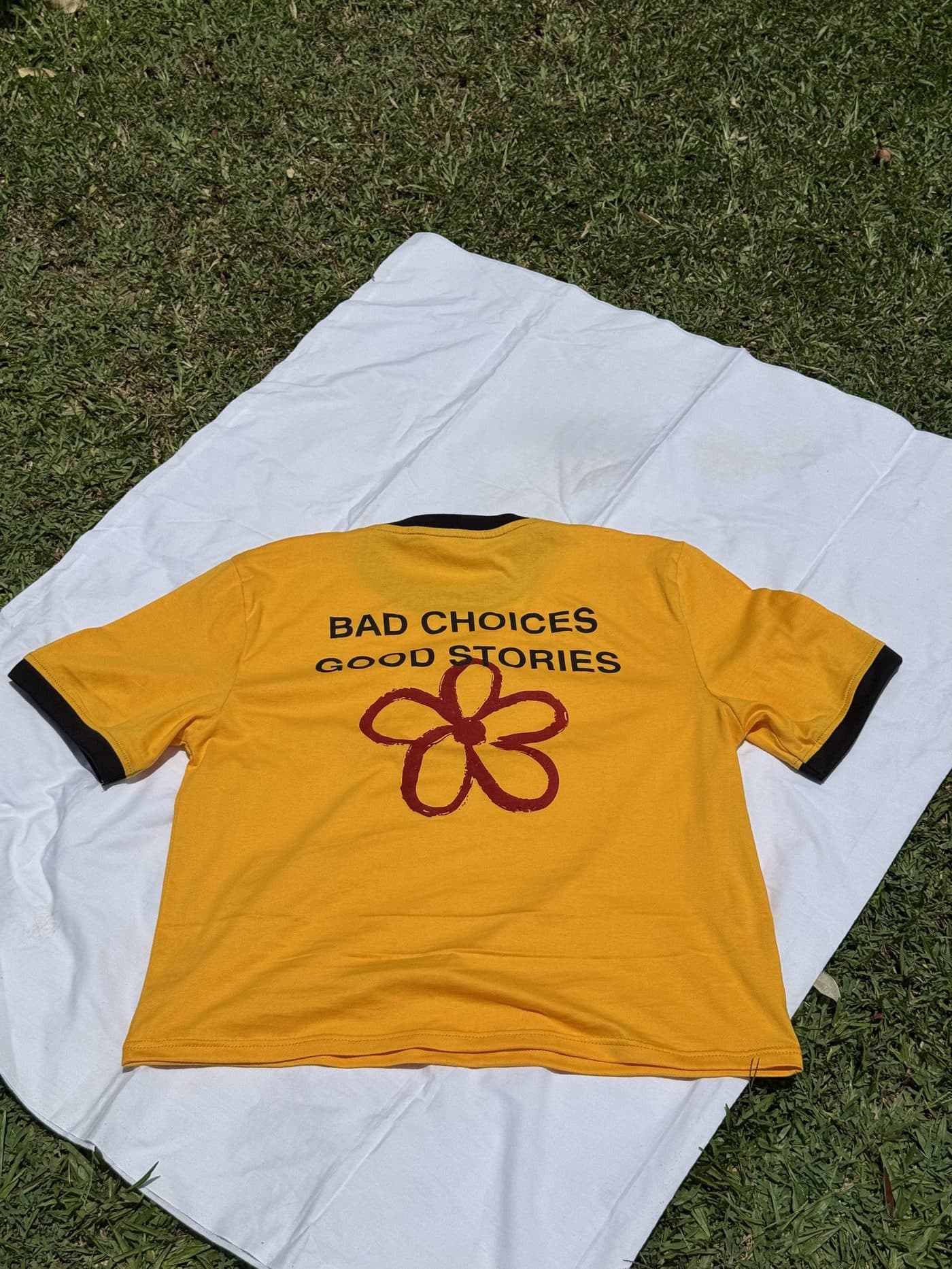 Back of the Bloom of Experience Crop with the red flower graphic